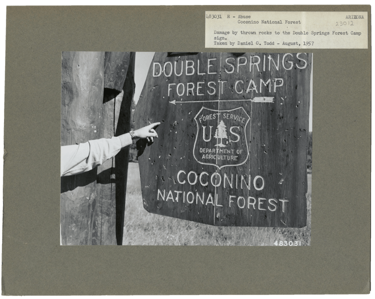 Sign damaged by thrown rocks